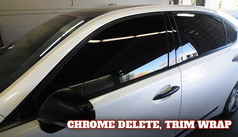 White Lexus sedan with black wrapped trim and door handles, gloss black vinyl.