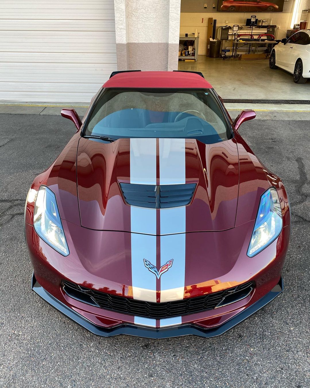 White dual stripes on burgundy Corvette.