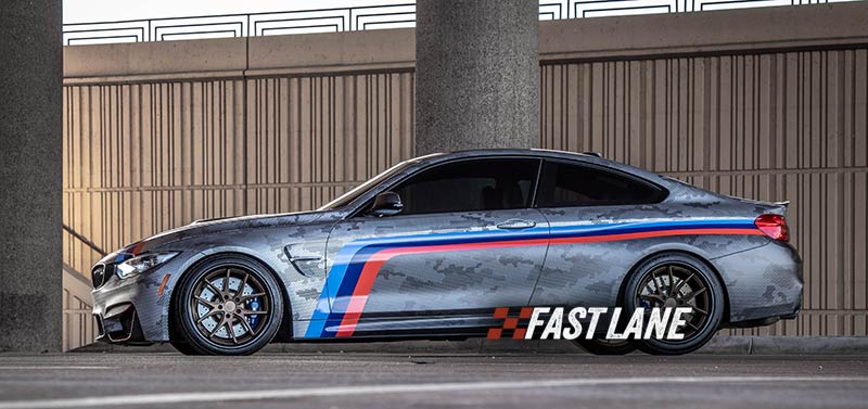 BMW M4 with vinyl wrap, decals, and printed design.