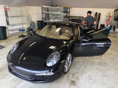 Black Porsche in for ceramic window tint all around.
