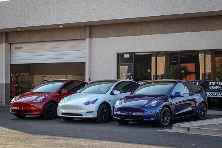 Three Teslas in front of Fast Lane