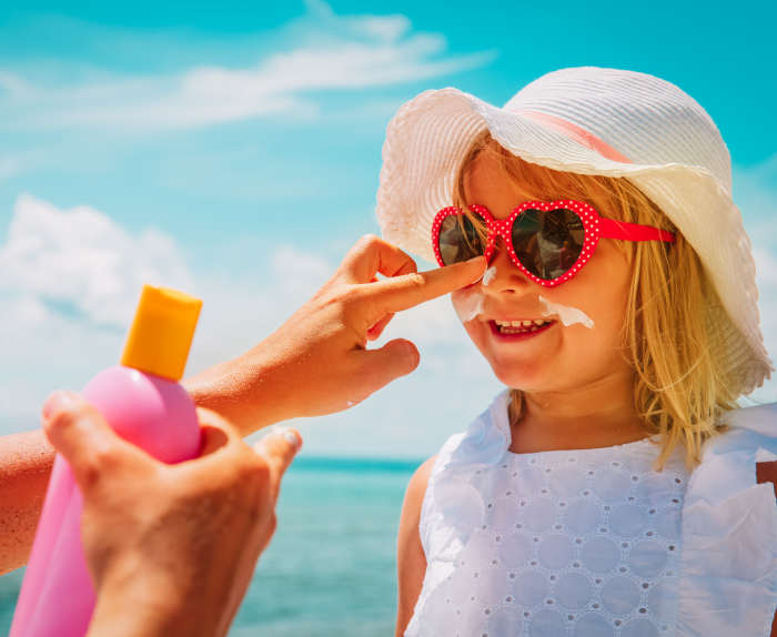 Putting sunscreen on a child