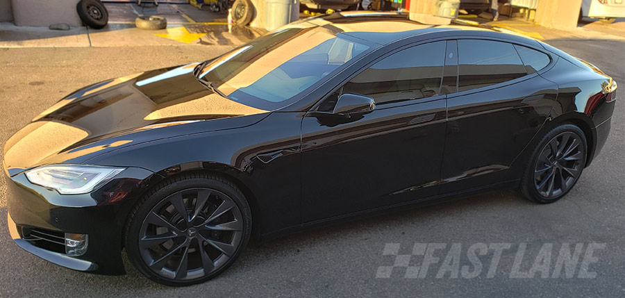 Matte charcoal wrapped Tesla with vinyl trim wrap / chrome delete.