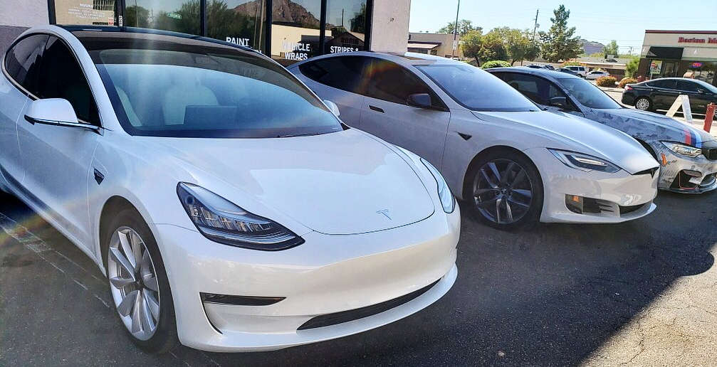 Several Teslas in our shop parking lot for window tint.