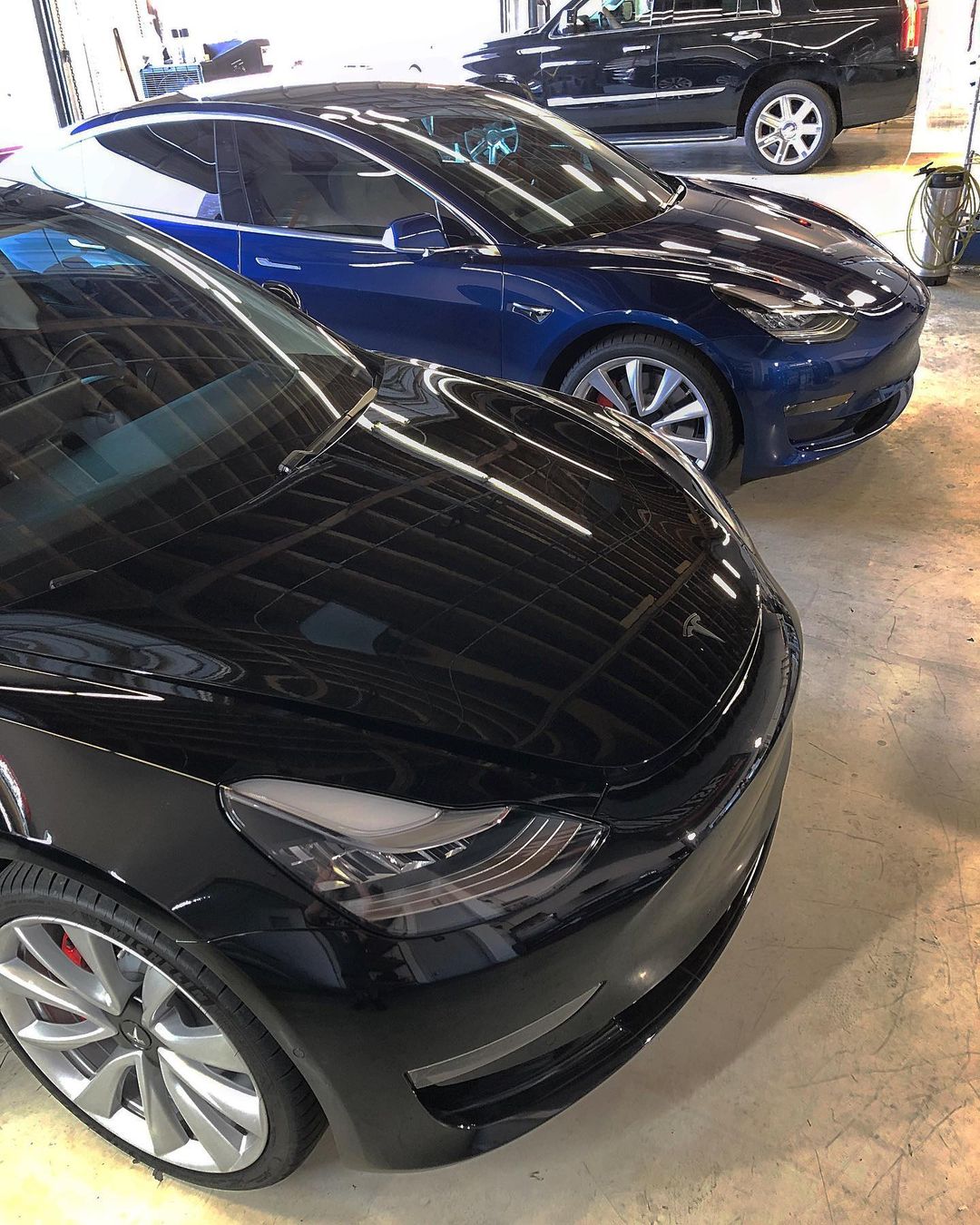 Tesla Model 3s in the shop