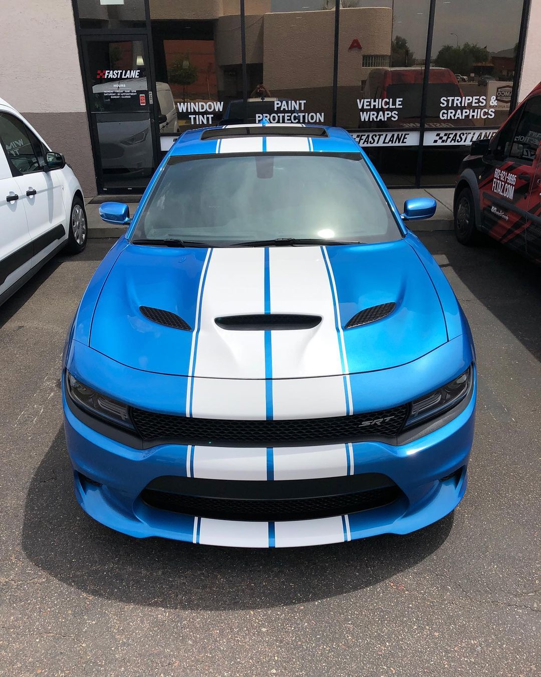 White dual stripes on Dodge Charger hellcat.
