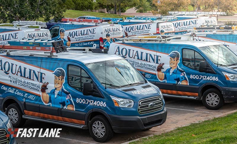 Marketing in motion: fleet of work trucks with vehicle graphics by Fast Lane.