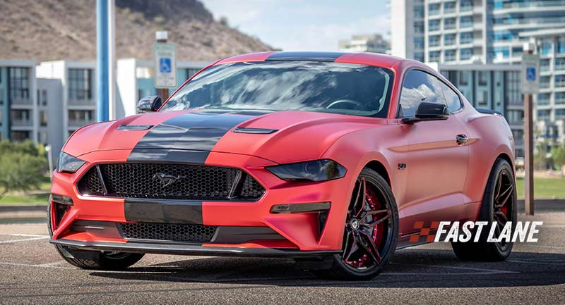 Red vinyl wrapped Mustang with black glossy stripe.